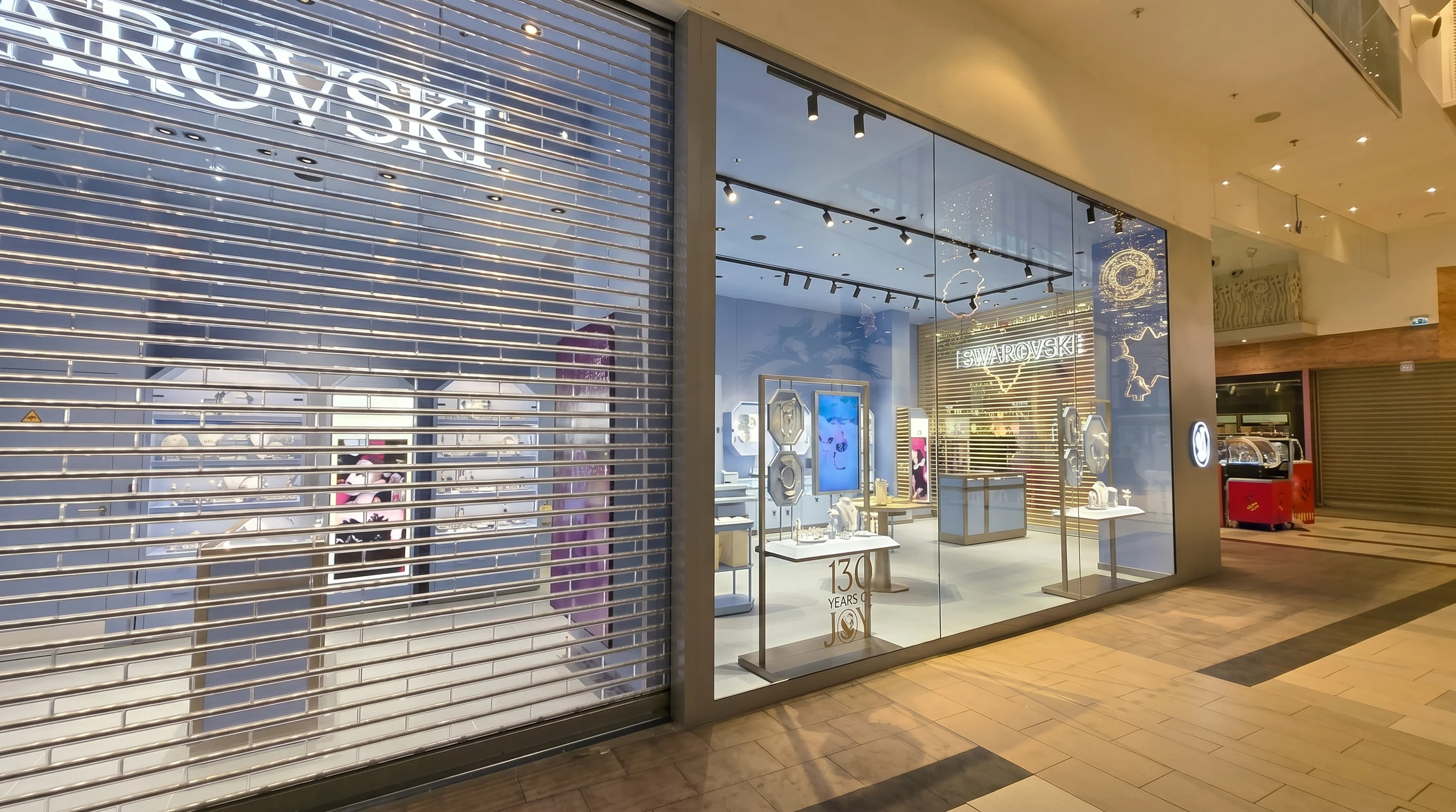 Façade commerciale extérieure avec rideau métallique fermé de couleur gris-bleu